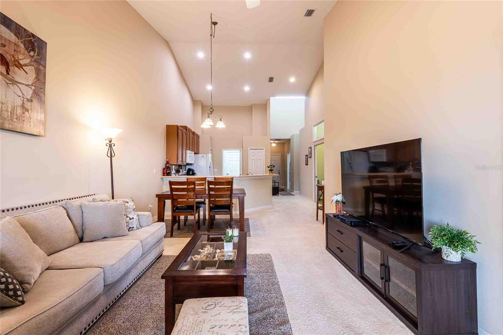 2735 Rutledge Court Winter Haven, FL 33884 - Photo 6 of 42 a living room with furniture and a flat screen tv