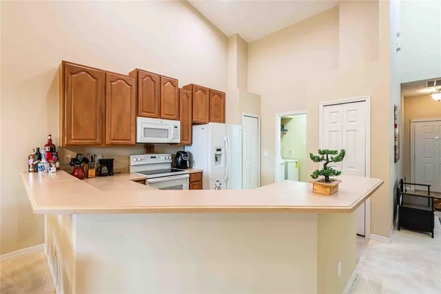 a kitchen with stainless steel appliances a stove a sink a refrigerator a microwave and cabinets