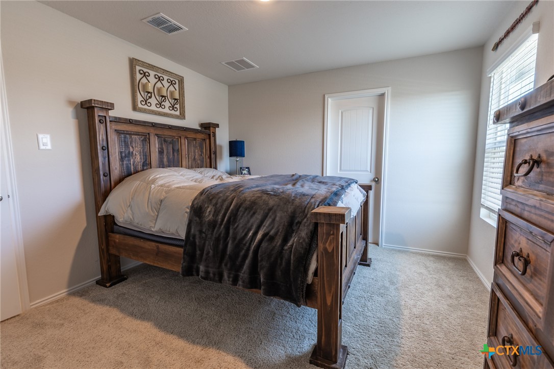 929 Indigo Way Seguin, TX 78155 - Photo 15 of 30 a bed sitting in a bedroom next to a window
