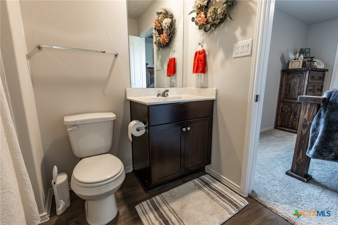 929 Indigo Way Seguin, TX 78155 - Photo 16 of 30 a bathroom with a toilet sink and a mirror