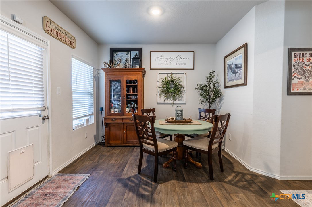 929 Indigo Way Seguin, TX 78155 - Photo 17 of 37 a view of a dining room with furniture and wooden floor