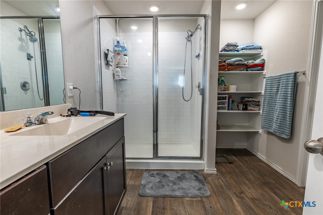 929 Indigo Way Seguin, TX 78155 - Photo 21 of 30 a bathroom with a sink a shower and a mirror