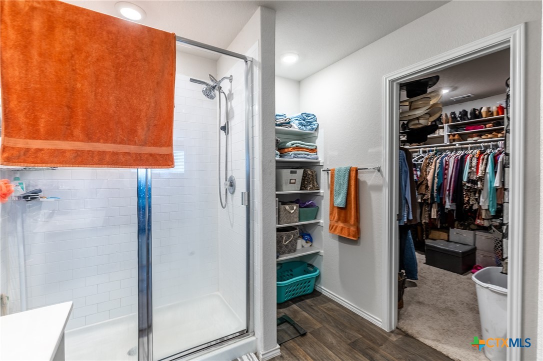 929 Indigo Way Seguin, TX 78155 - Photo 23 of 37 a view of walk in closet with clothes and shoes