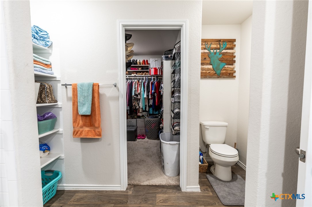 929 Indigo Way Seguin, TX 78155 - Photo 24 of 37 a bathroom with a toilet and a shower curtain