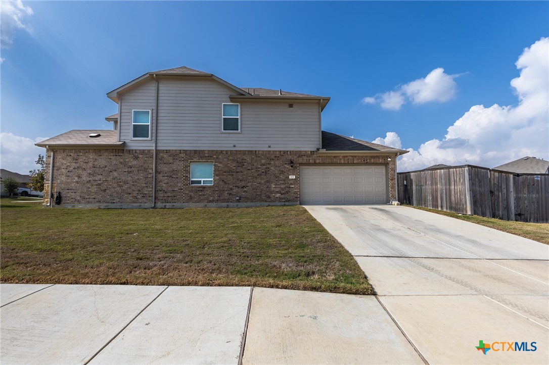 929 Indigo Way Seguin, TX 78155 - Photo 3 of 30 a front view of a house with a yard