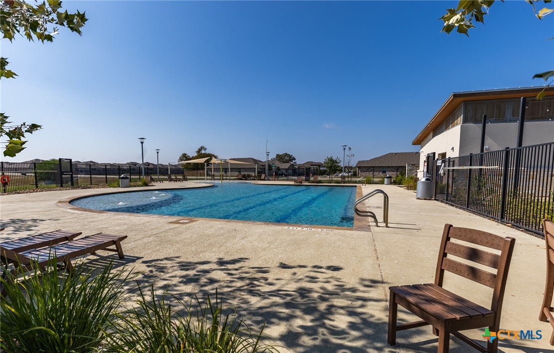 929 Indigo Way Seguin, TX 78155 - Photo 34 of 37 a view of a swimming pool with a lounge chair
