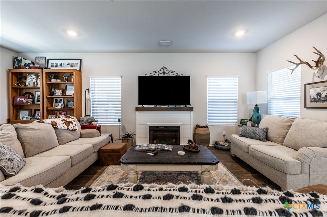 929 Indigo Way Seguin, TX 78155 - Photo 5 of 37 a living room with furniture a rug and a fireplace