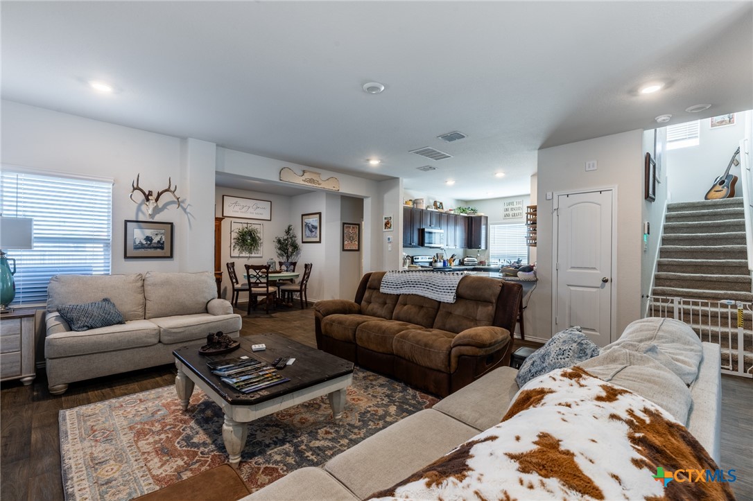 929 Indigo Way Seguin, TX 78155 - Photo 8 of 37 a living room with furniture ceiling fan and a rug