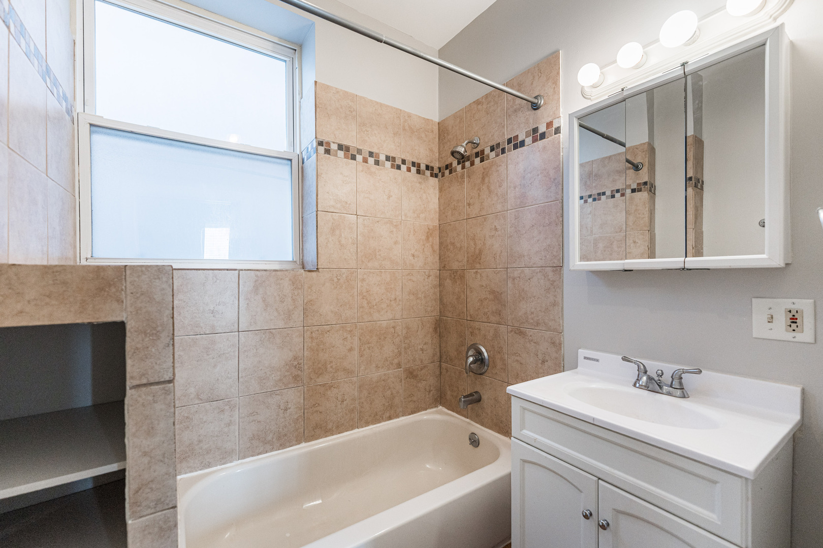 2916 West Warren Boulevard, Unit 1 Chicago, IL 60612 - Photo 12 of 16 a bathroom with a sink and a bathtub