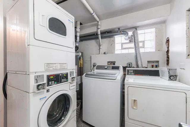 a view of washer and dryer with kitchen in the background