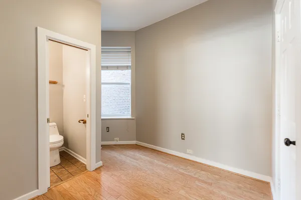 a bathroom with a granite countertop toilet and a sink