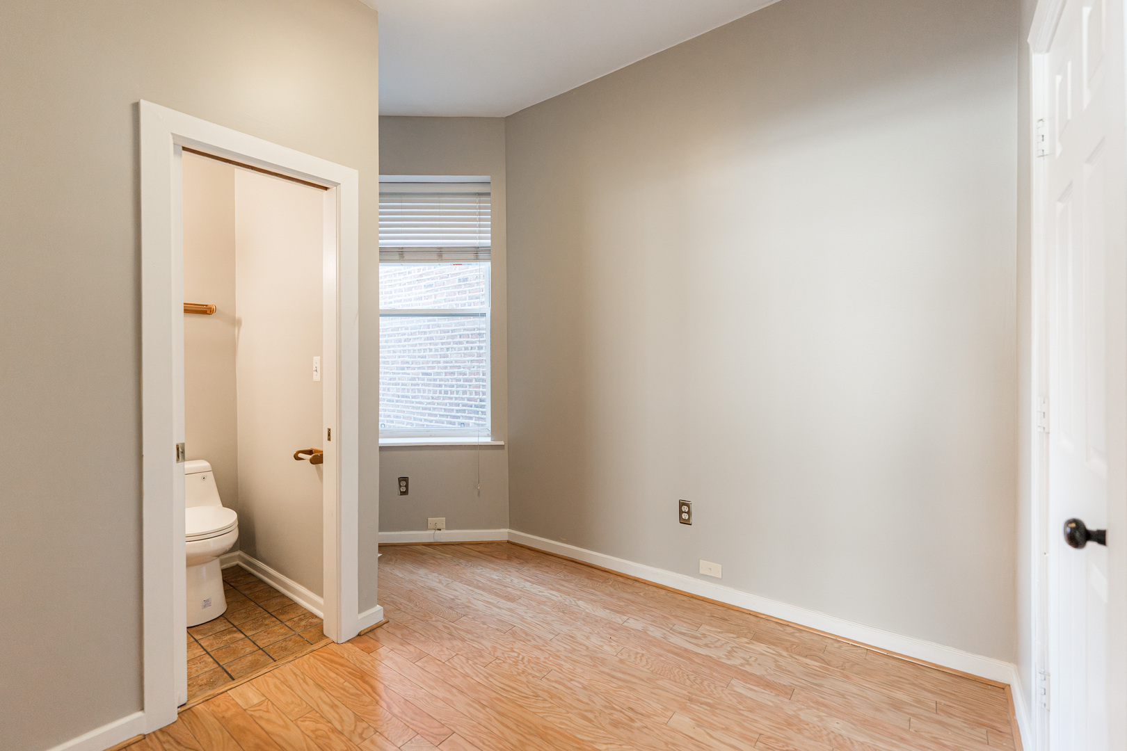2916 West Warren Boulevard, Unit 1 Chicago, IL 60612 - Photo 8 of 16 a bathroom with a granite countertop toilet and a sink