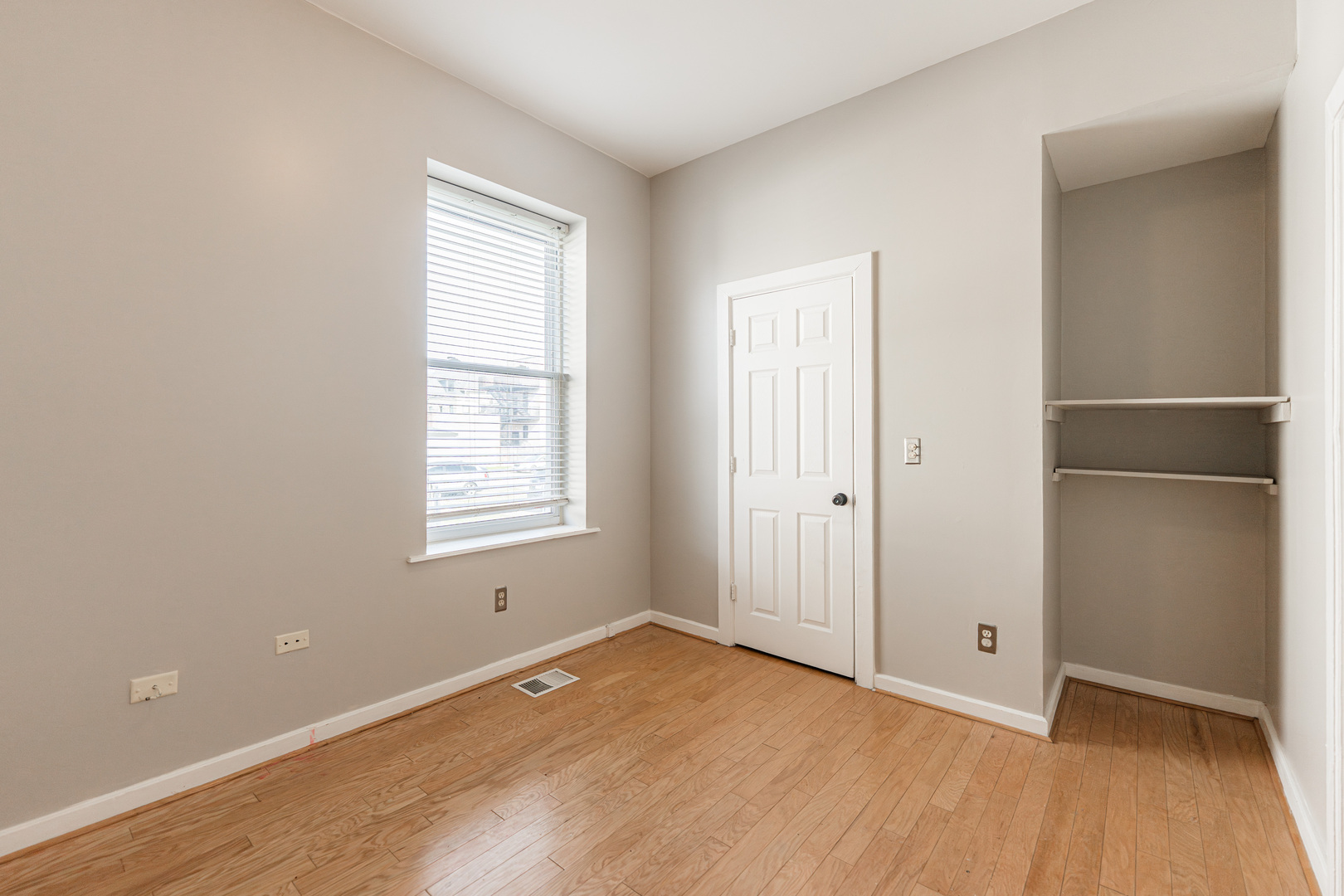 2916 West Warren Boulevard, Unit 1 Chicago, IL 60612 - Photo 10 of 16 a view of an empty room with wooden floor and a window
