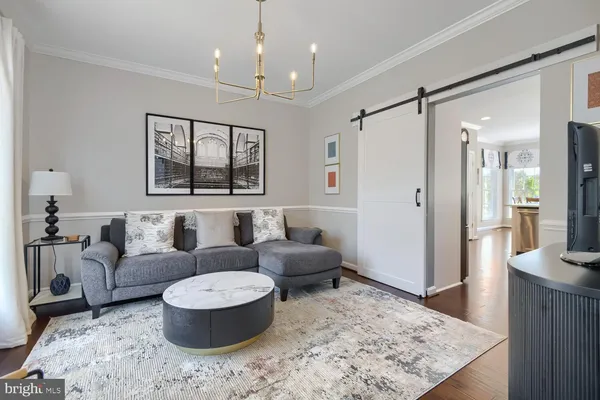 a living room with furniture and a chandelier