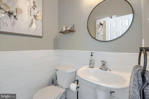 a bathroom with a toilet a sink and a mirror