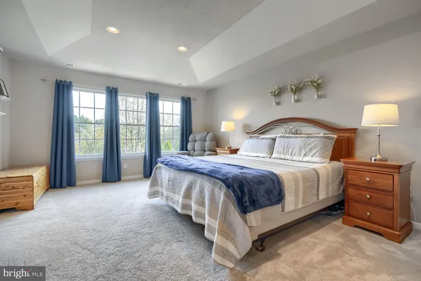 a spacious bedroom with a bed and a large window