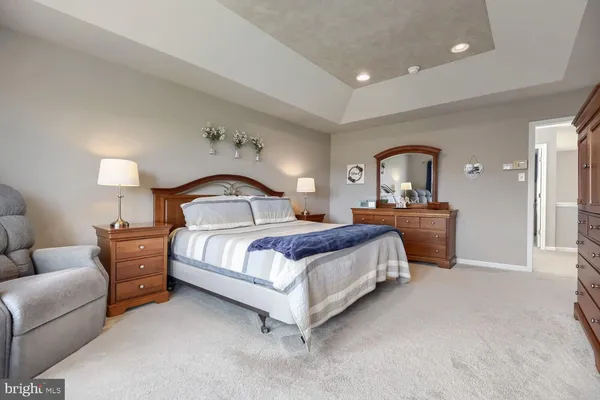 a bedroom with a bed and a lamp on table