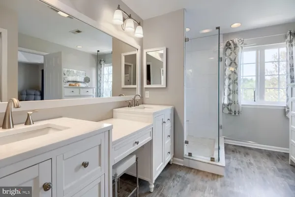 a spacious bathroom with a double vanity sink mirror and double
