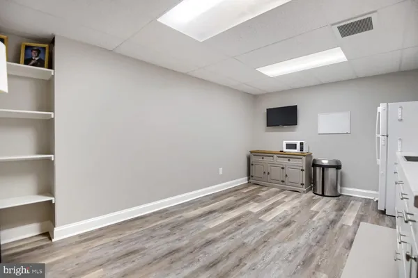 a room with a wooden floor and furniture