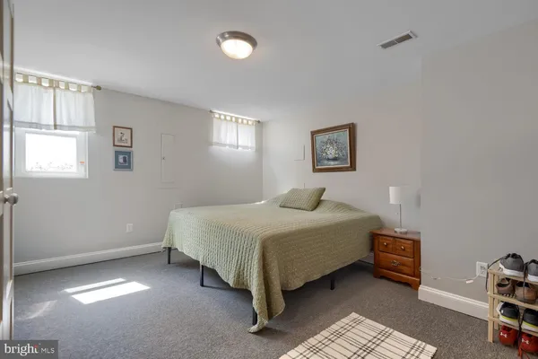 a spacious bedroom with a bed and a window