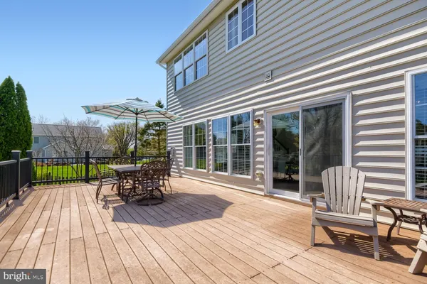 a view of a patio with table and chairs wooden floor and fence