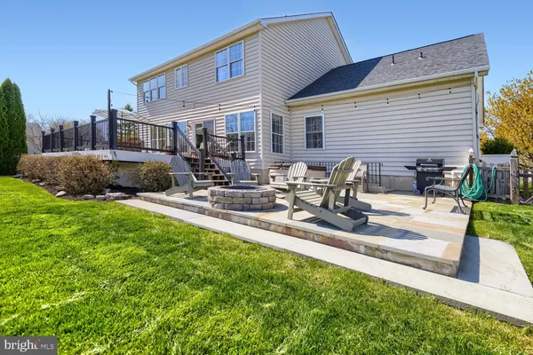 a front view of a house with a garden and patio