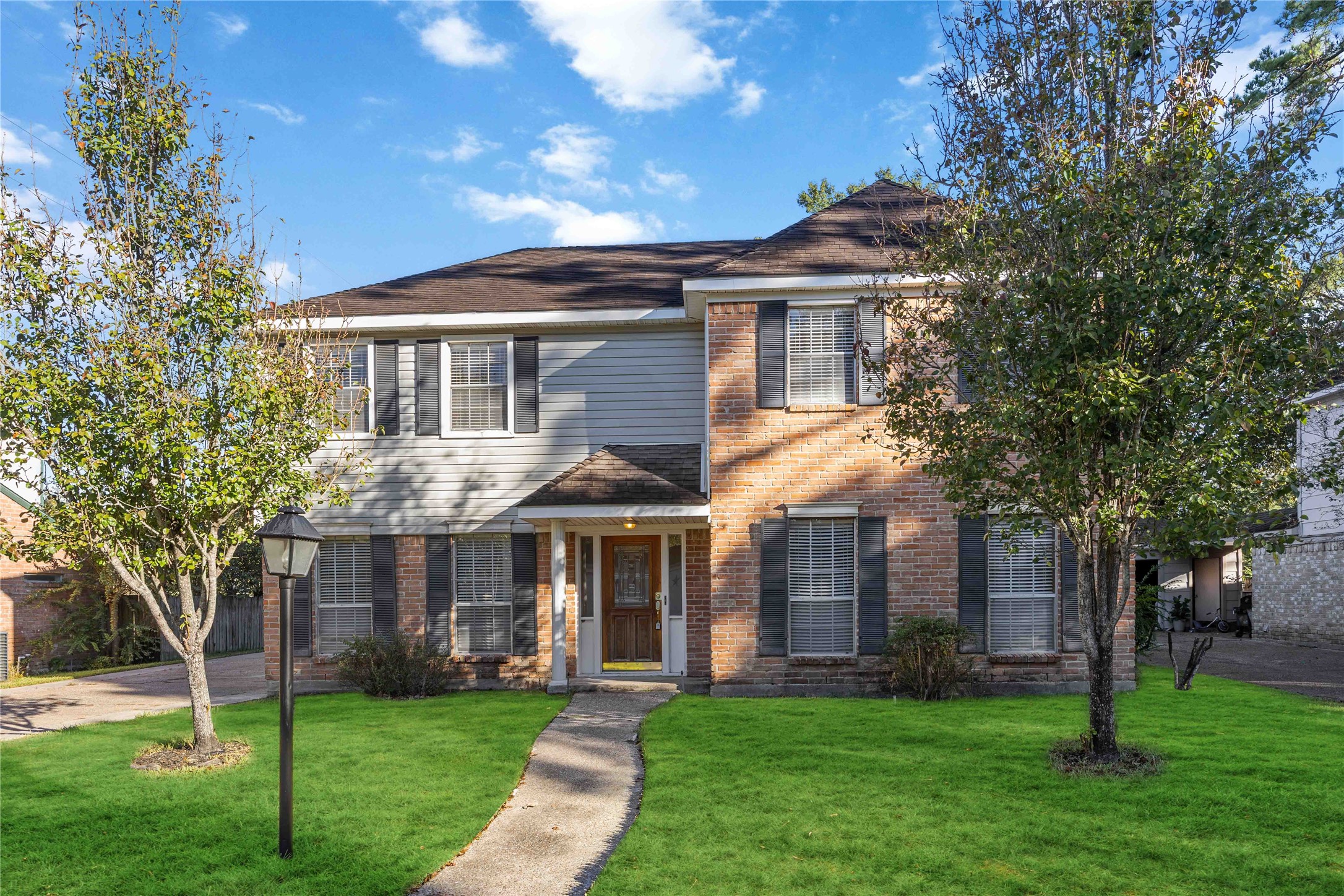 a front view of a house with a garden
