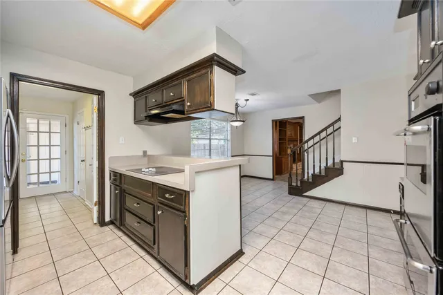 a kitchen with stainless steel appliances granite countertop a stove and a sink