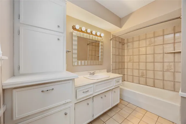 a bathroom with a sink a large mirror and a bathtub