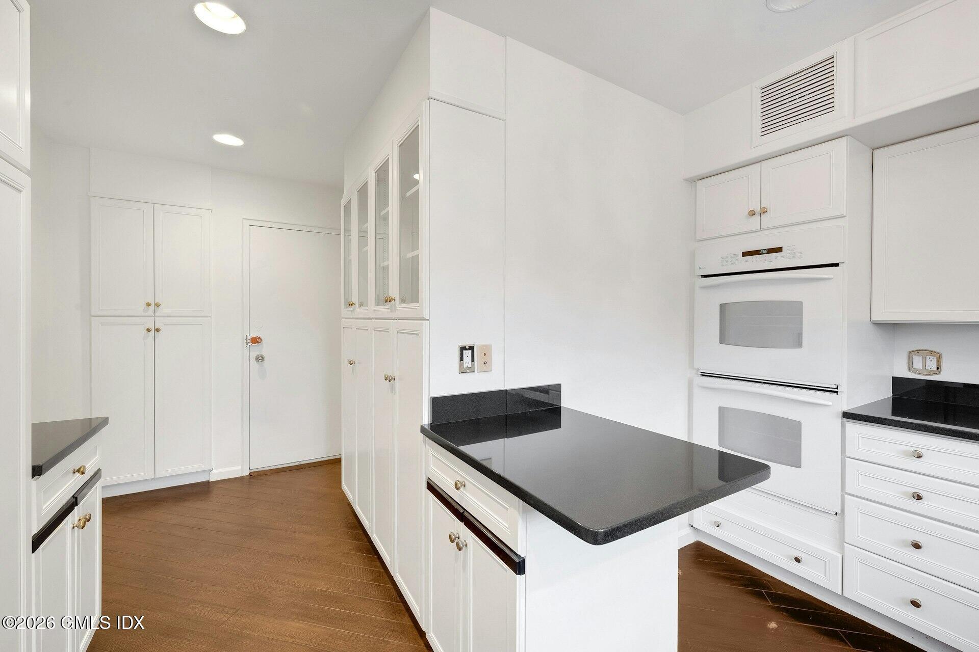 630 Steamboat Road, Unit 4AN Greenwich, CT 06830 - Photo 9 of 32 a kitchen with a stove and a kitchen island