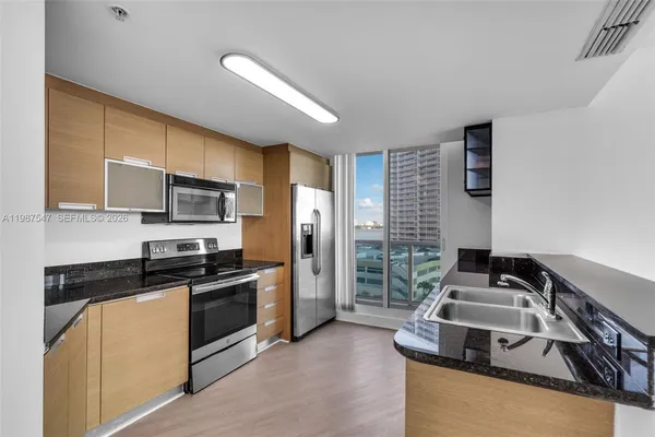a kitchen with stainless steel appliances granite countertop a stove and a sink