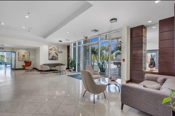 a living room with furniture and a large window