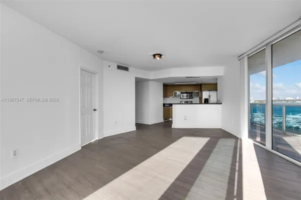 a big room with wooden floor and windows