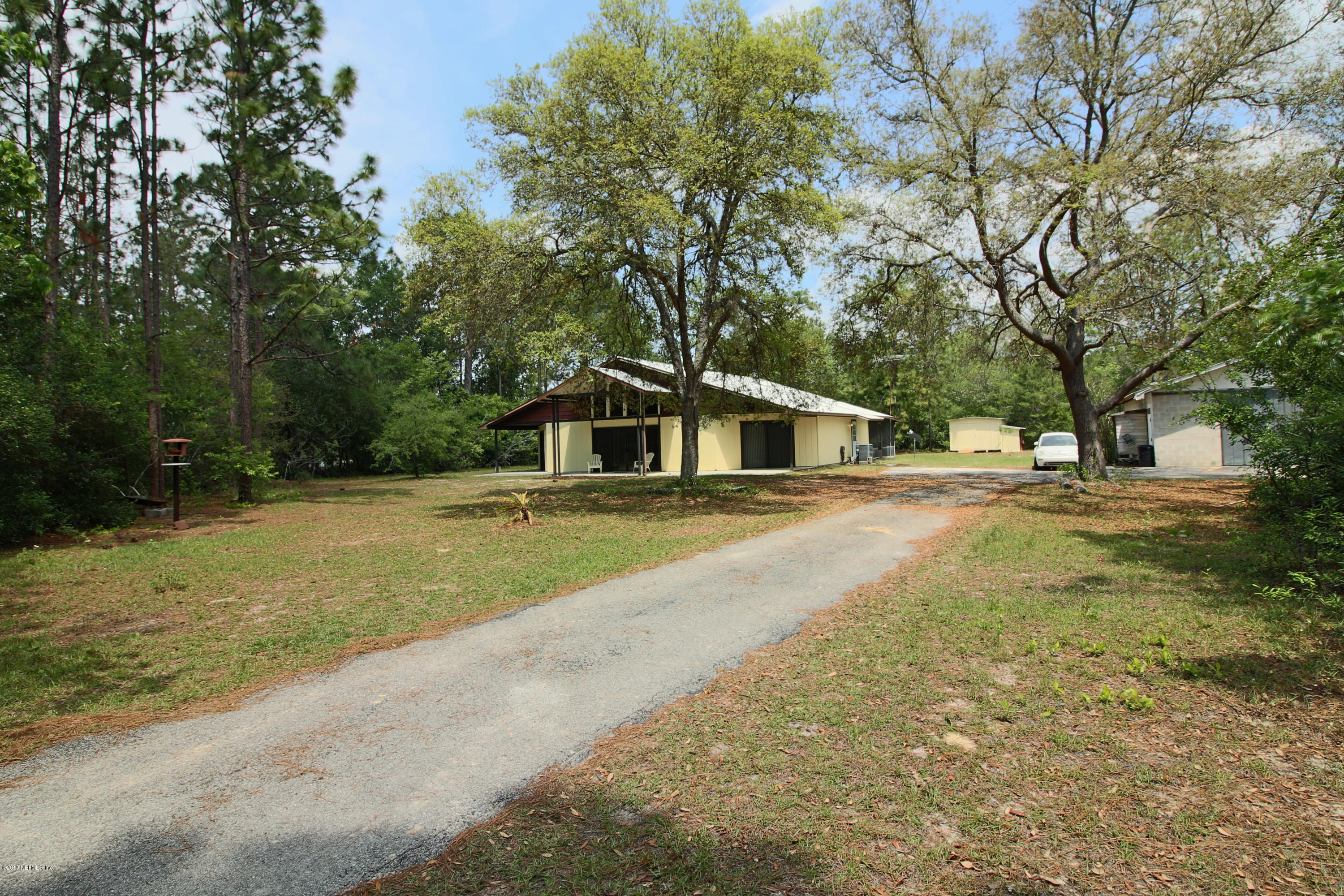 7705 Ranchette Road Keystone Heights, FL 32656 - Photo 2 of 29 a house with trees in the background