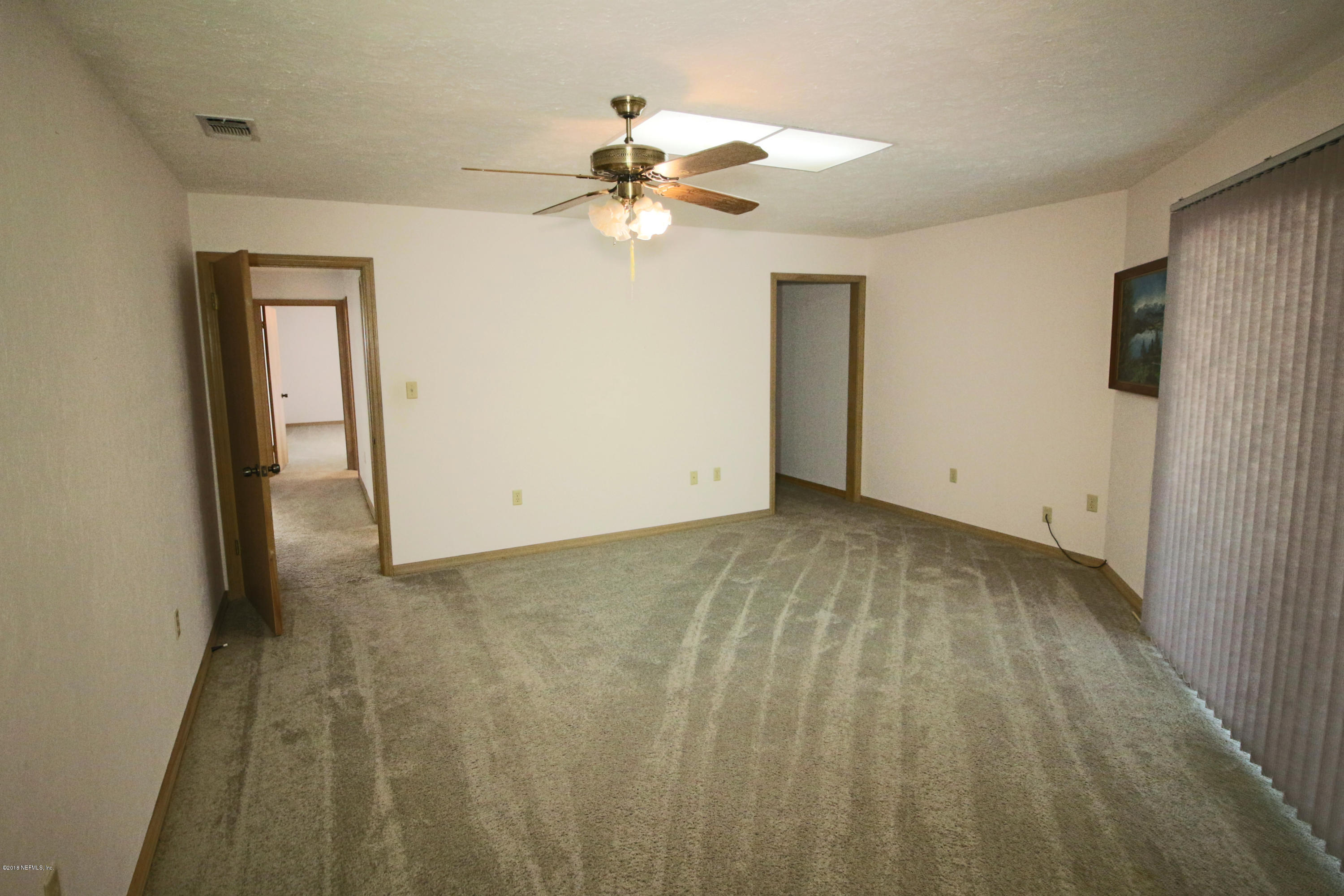 7705 Ranchette Road Keystone Heights, FL 32656 - Photo 9 of 29 a view of a livingroom with a chandelier fan