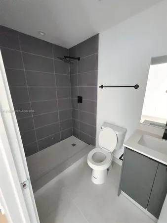 a bathroom with a shower and a toilet
