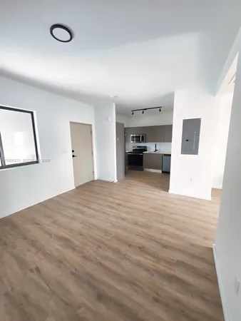a view of a kitchen with a sink and a refrigerator