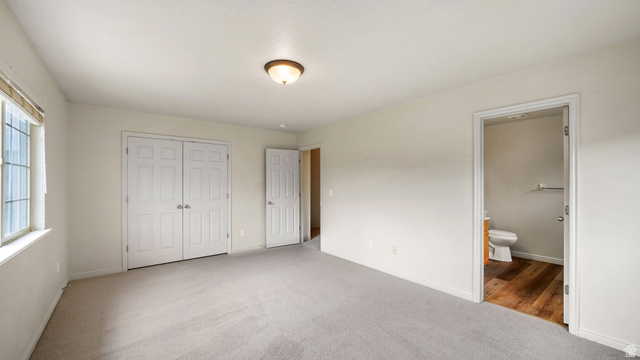 983 South 1850th Street West Springville, UT 84663 - Photo 10 of 30 Spacious room featuring neutral carpeting, a large window, and double closet doors