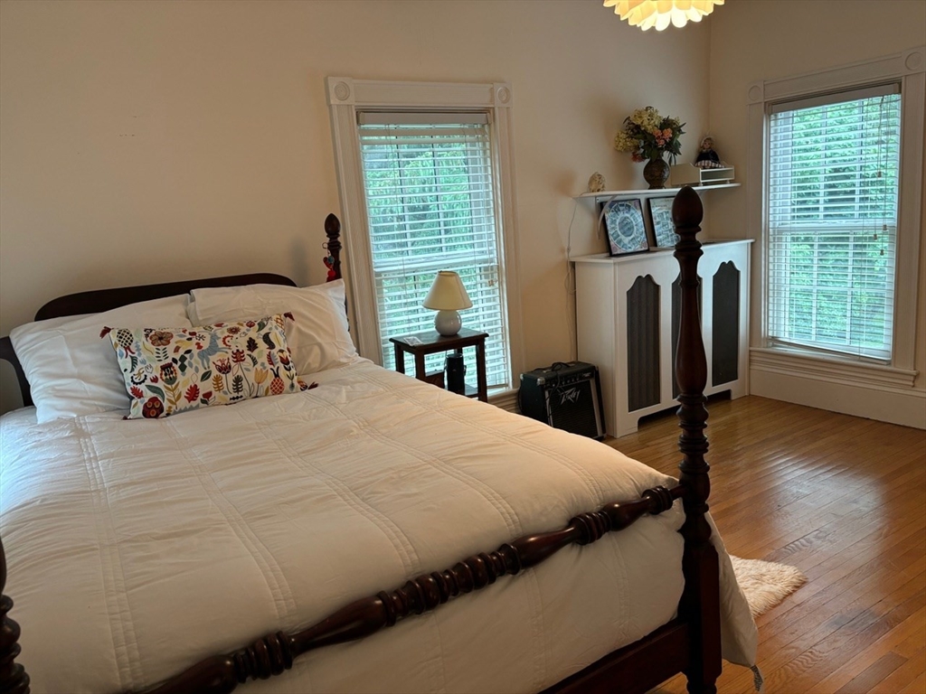 674 Webster Street Needham, MA 02492 - Photo 8 of 10 a bedroom with a bed wooden floor and window