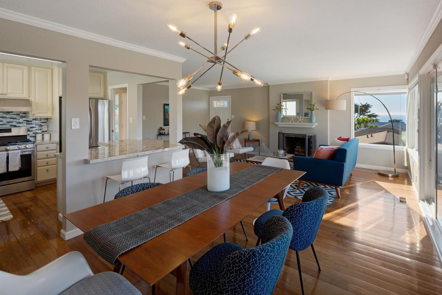 17 Moon Gate Court Pacifica, CA 94044 - Photo 12 of 36 a living room with furniture a fireplace and a chandelier