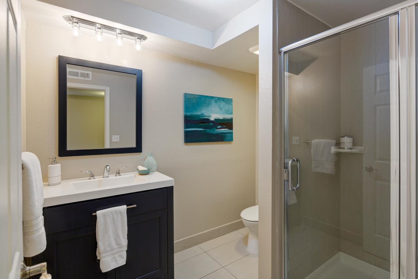 17 Moon Gate Court Pacifica, CA 94044 - Photo 30 of 36 a bathroom with a sink vanity mirror and toilet