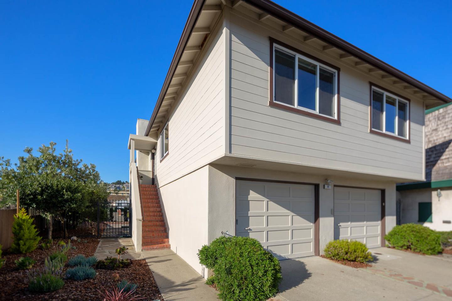 17 Moon Gate Court Pacifica, CA 94044 - Photo 3 of 36 a front view of a house with garden