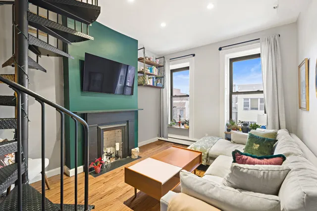 a living room with furniture tv and a fireplace