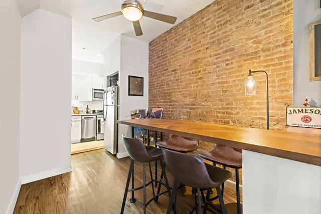 a view of a kitchen with a table and chairs