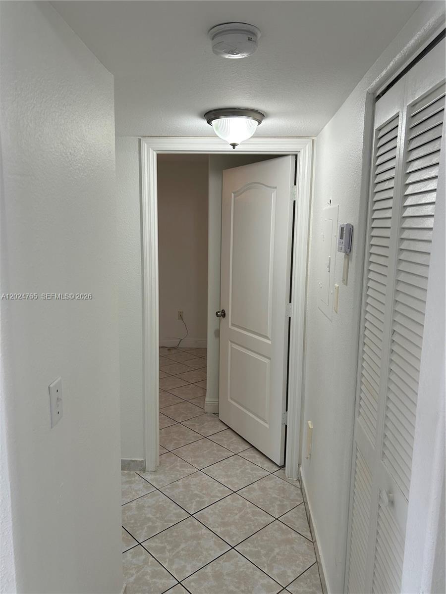10919 West Okeechobee Road, Unit 101 Hialeah Gardens, FL 33018 - Photo 15 of 21 a view of a hallway