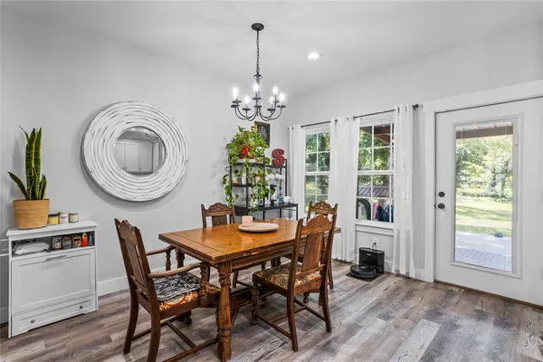 a dining room with furniture a chandelier and a rug