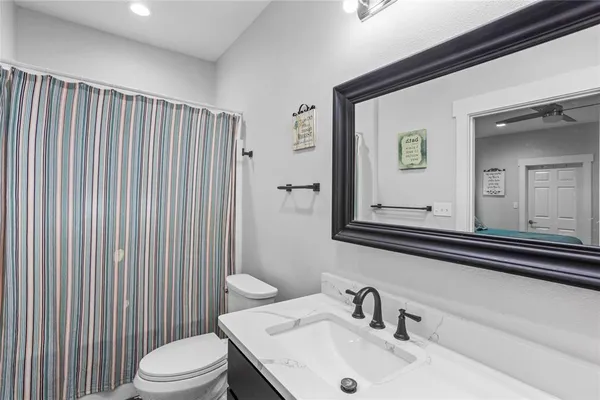 a bathroom with a sink a toilet and mirror