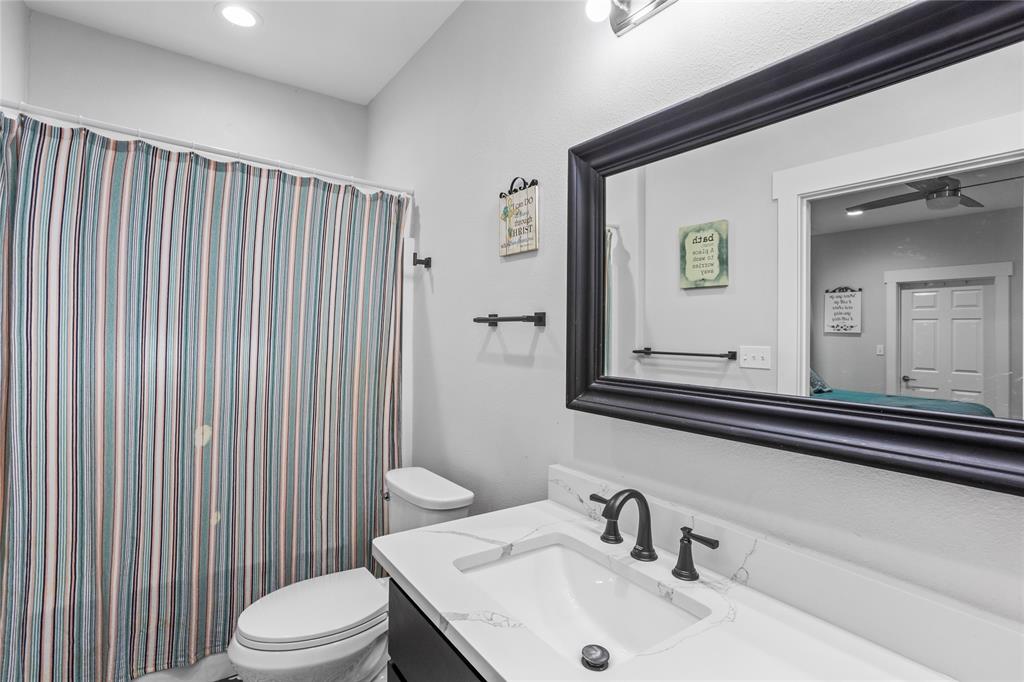 1685 Fleming Road Bells, TX 75414 - Photo 14 of 30 a bathroom with a sink a toilet and mirror