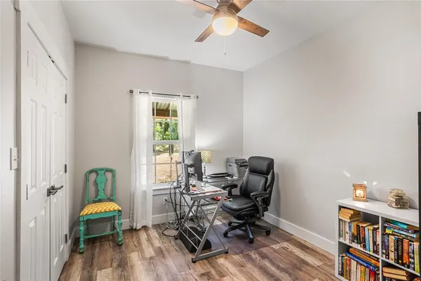 a view of a workspace with furniture and a window