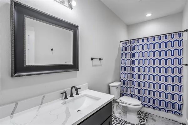 a bathroom with a sink toilet and mirror